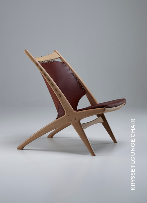 Eikund Krysset lounge chair with white oiled oak and brown leather in white background