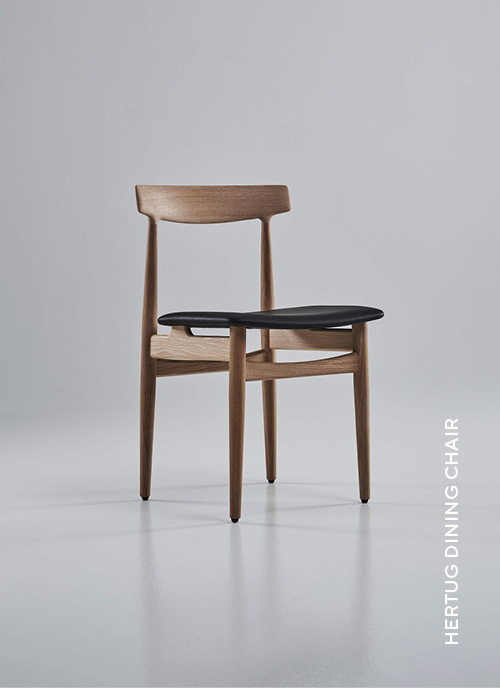 Eikund Hertug Dining Chair in oiled oak frame and black leather upholstery in white background